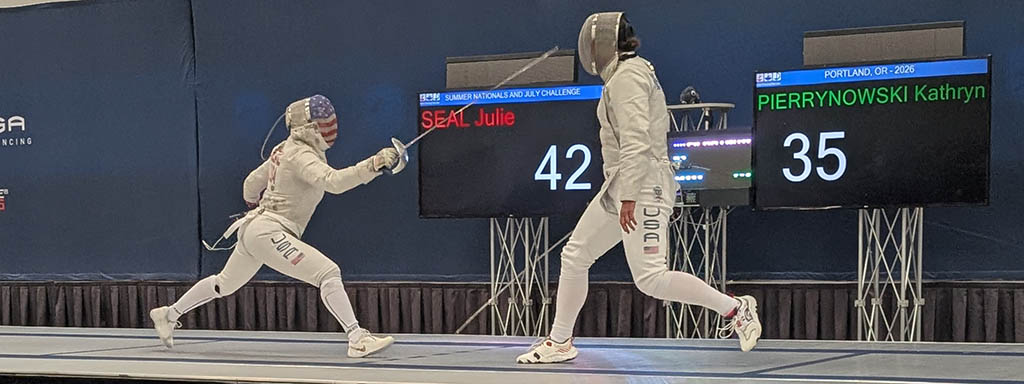 Kathryn fencing a sabre bout on the strip