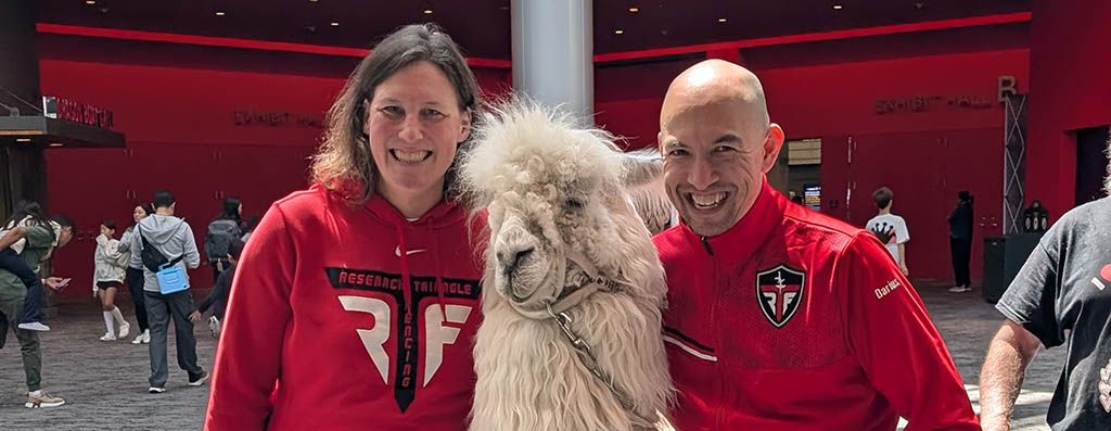 RTF coaches posing with a llama mascot at the venue